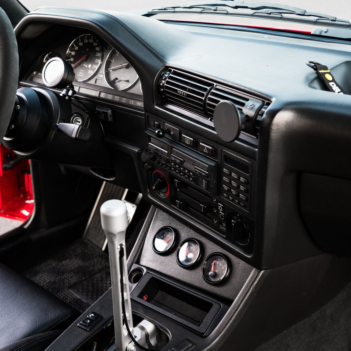 BMW E30 interior showing the phone mount position above the radio