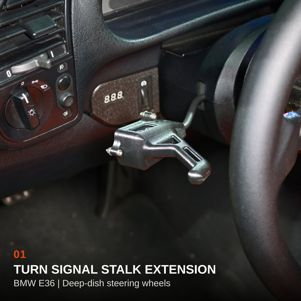 BMW E36 turn signal stalk extension installed beside a deep-dish steering wheel