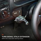 BMW E36 turn signal stalk extension installed beside a deep-dish steering wheel