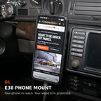 BMW E38 phone mount beside the center display, holding a phone with a cable connected directly to it.