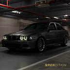 BMW E39 LED projector headlights with white halo rings and sharp beam pattern