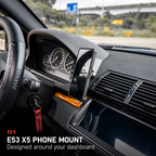 BMW E53 X5 phone mount with a phone installed beside the instrument cluster.