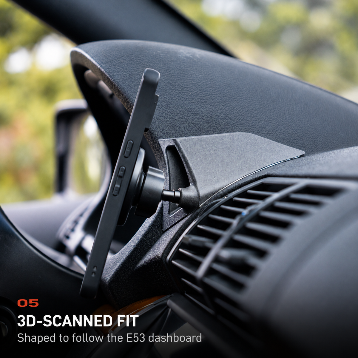 Side view of the BMW E53 X5 phone mount showing its 3D-scanned fit against the dashboard contour.